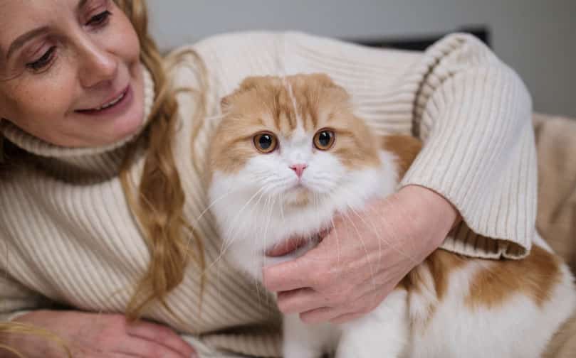 Woman enjoying the comfort of her ESA/emotional support cat, emotional support animal